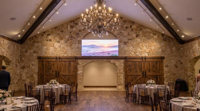 LED display in a stone-walled wedding venue
